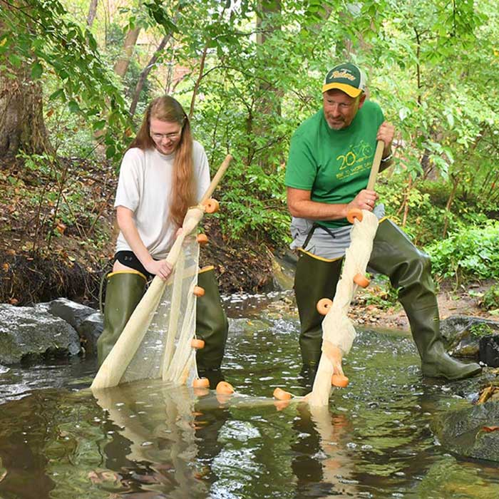 student research in river with Professor Jay Nelson