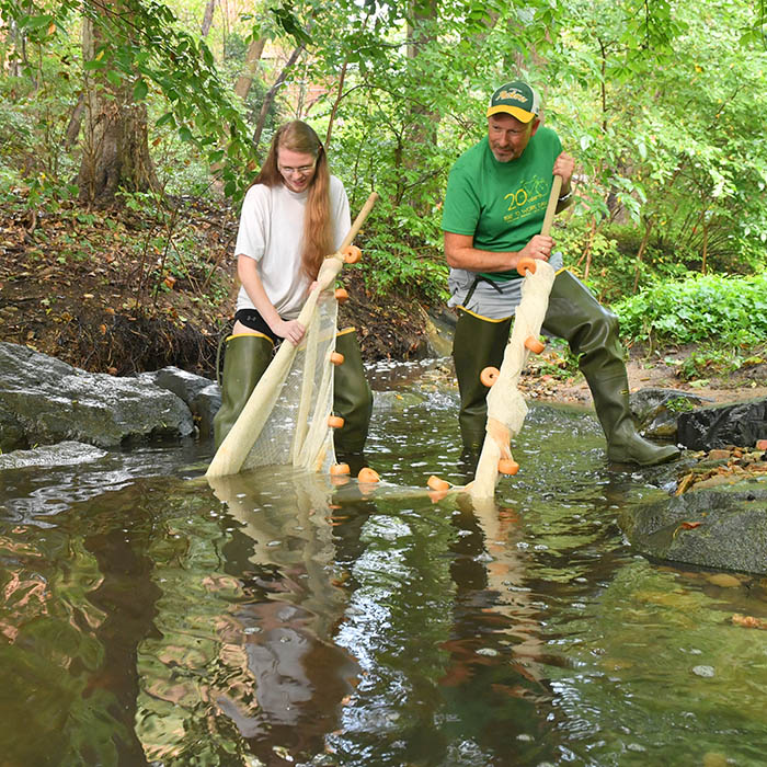 Faculty and student doing field research