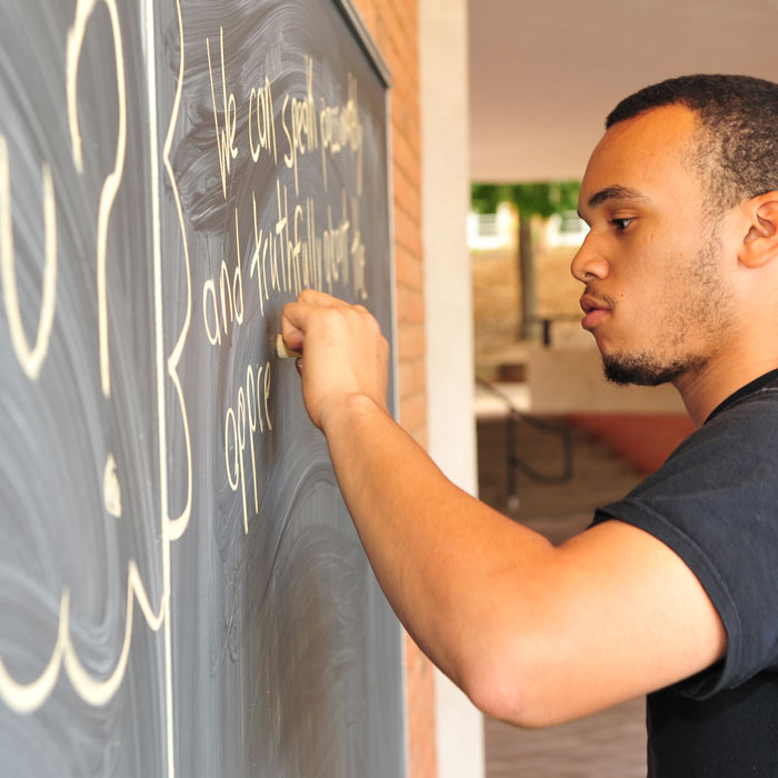 Man writing on chalkboard