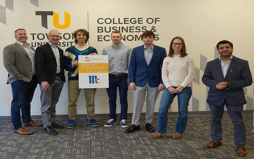 Third place team poses with judges
