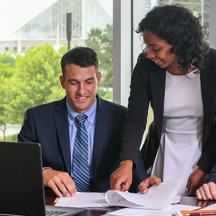 two interns working together at a table