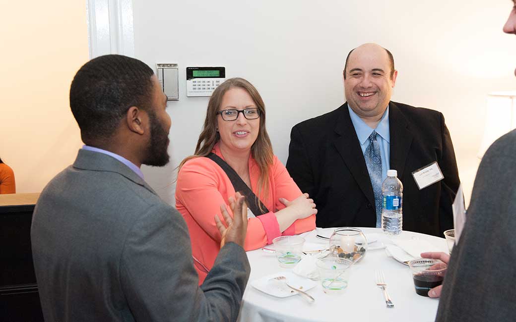alums chatting at a networking event alums chatting at a networking event
