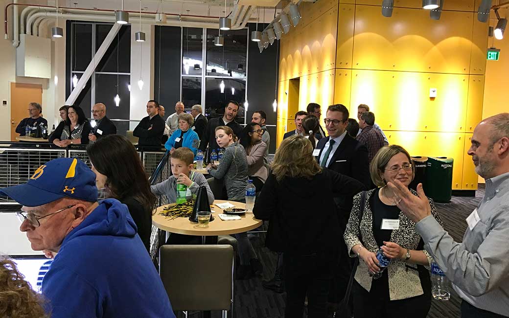 alums and friends networking on the suite level of TU arena