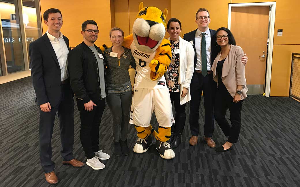 young alums Young alumni posing with Doc the Tiger at one of the TU men's basketball games