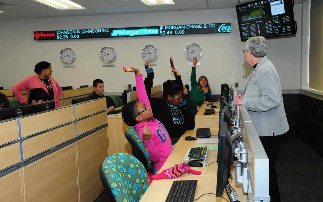 students in finance lab middle school students learning about finance in the T. Rowe Price finance Lab