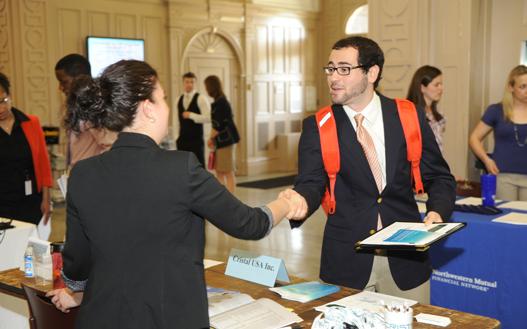 Student shaking hands with employer at the CBE career fair