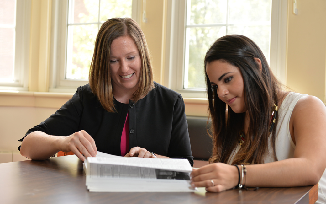 student academic and career services adviser helps a cbe student