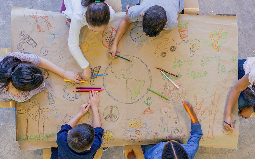 Children drawing image of globe