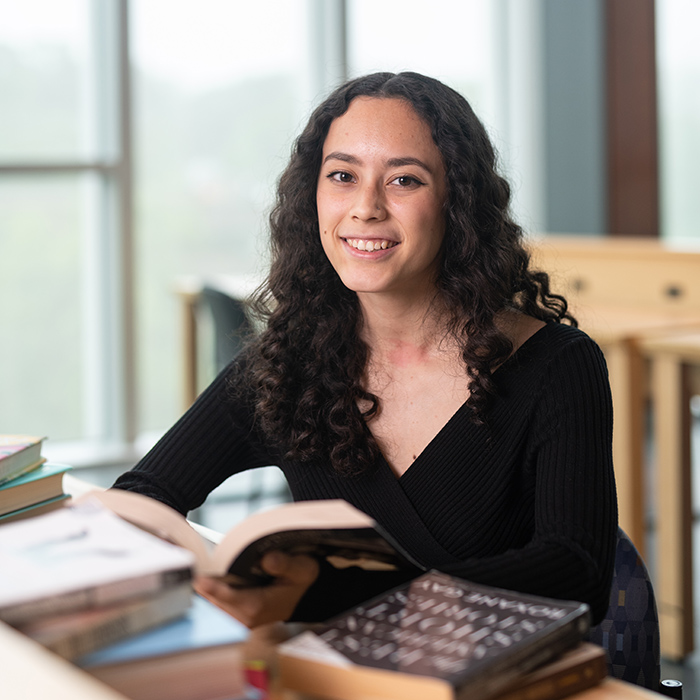 Student at desking with books