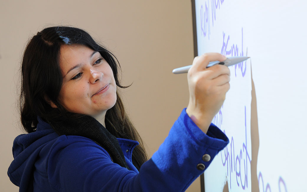 Writing on a smartboard.