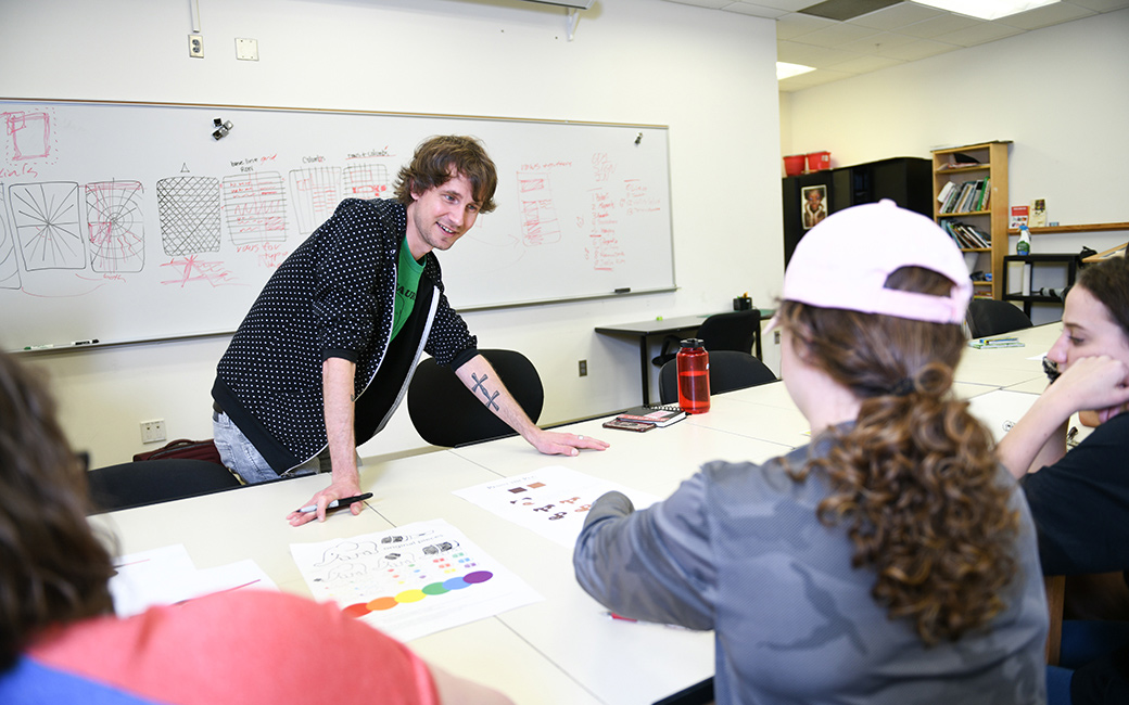 graphic design faculty member with students in foreground