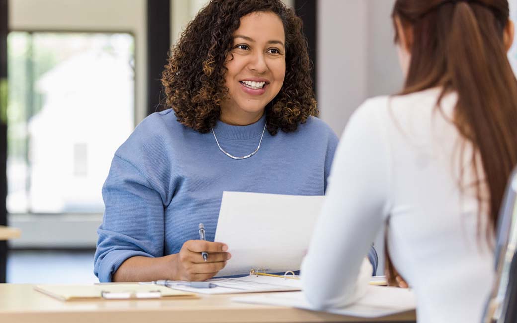 woman addressing group of people as if in a training session