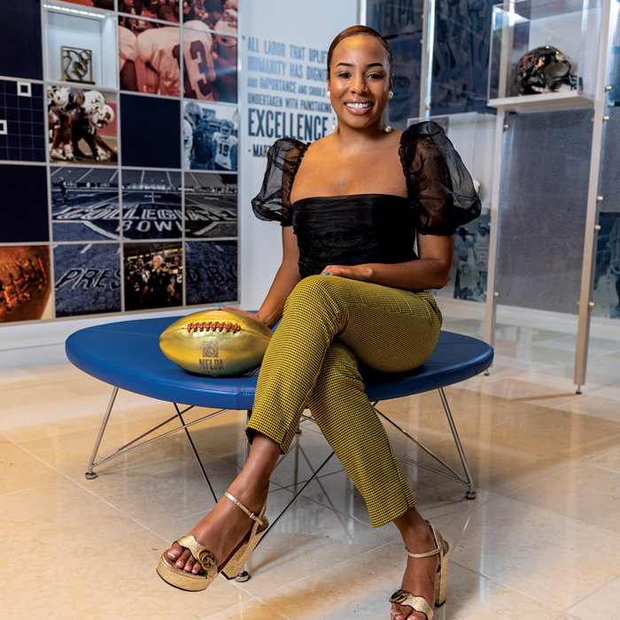 Leslie Isler sitting with a gold football