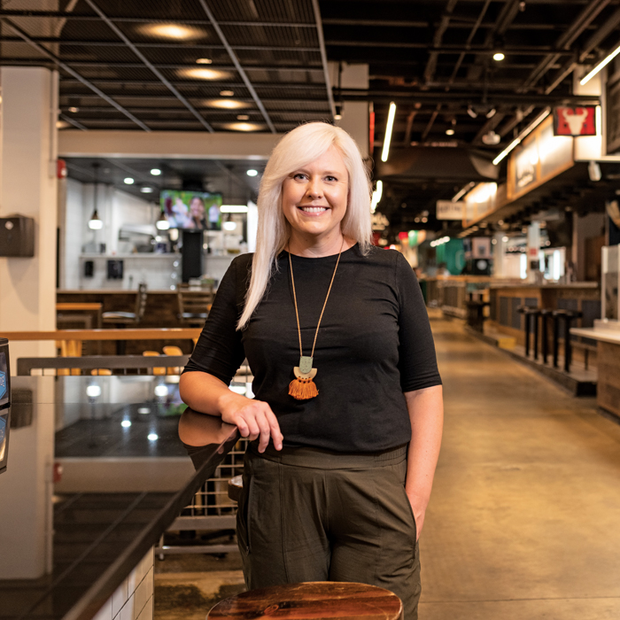 Candice Coolahan in indoor food market with stalls in the background