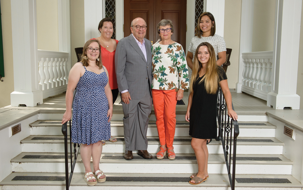 Donors Alena and David M. Schwaber with students in front of the Auburn House