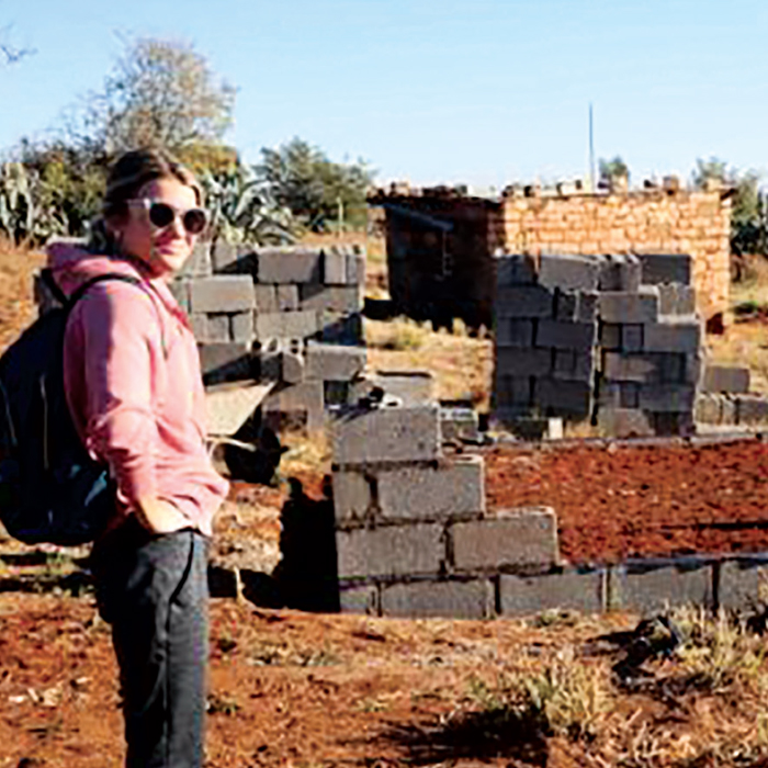 white woman standing at building site