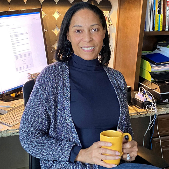 Linda Singh holding coffee cup