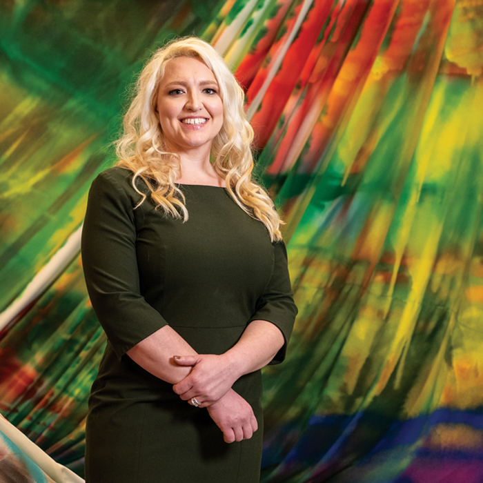 white woman in front of abstract art