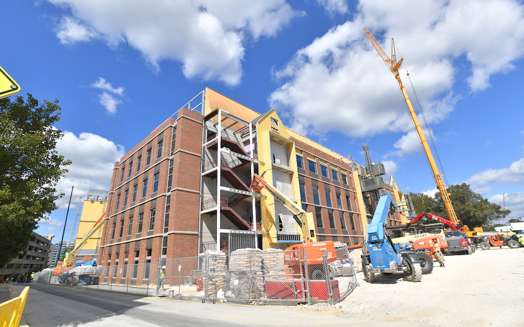 side view of a building construction with a crane