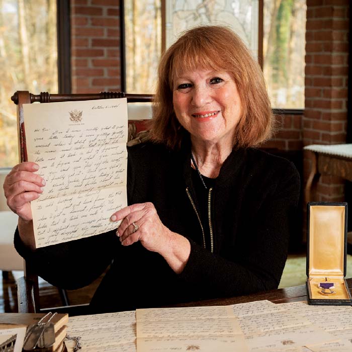 Jackie Cohen holding up a letter