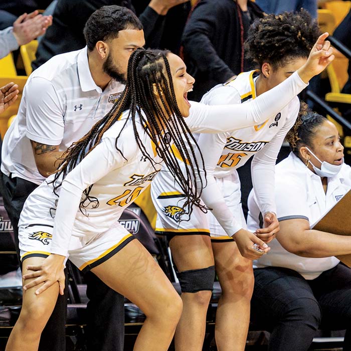 women's basketball players cheering