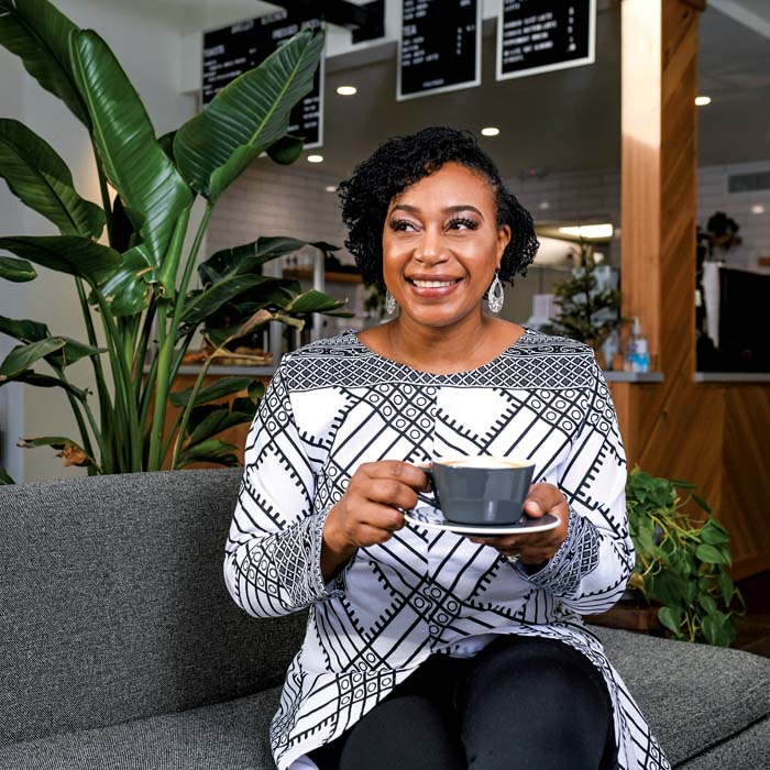 Rhea Roper Nedd with a coffee mug