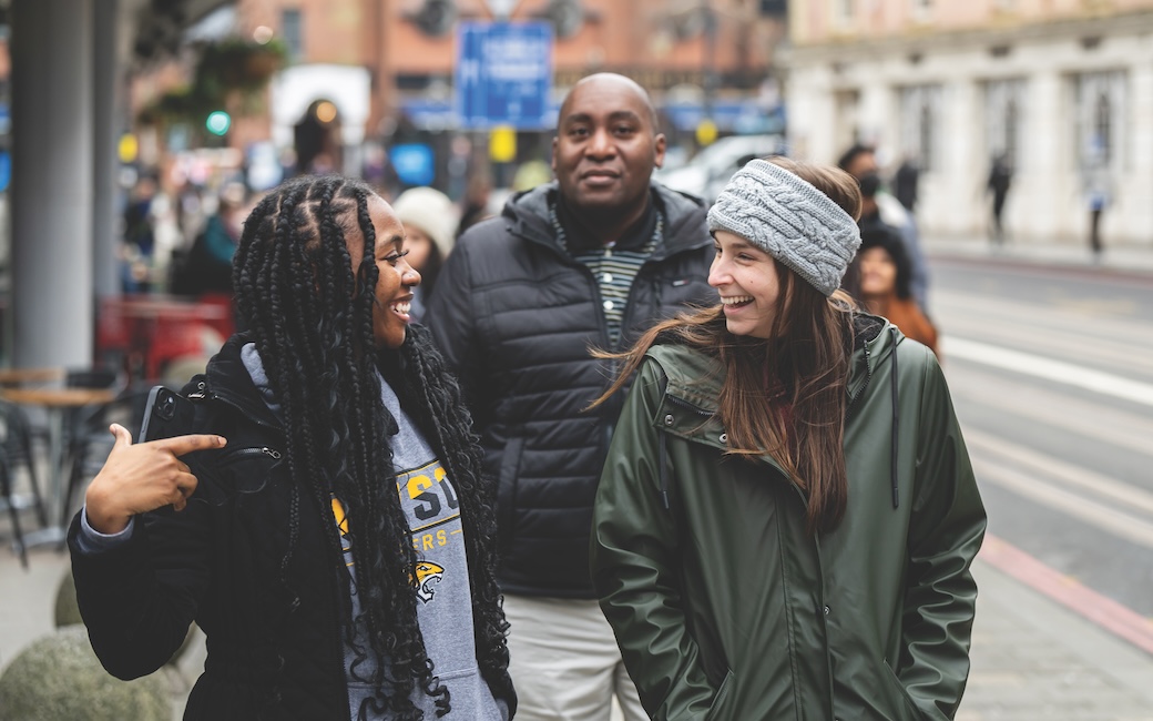Two TU students looking at each other and laughing