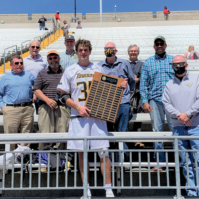 Color image of a group of people in Unitas Stadium's bleachers
