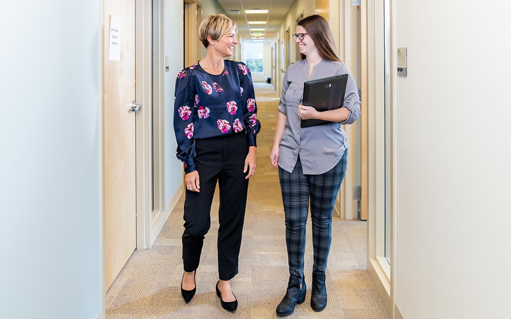Women talk in hallway