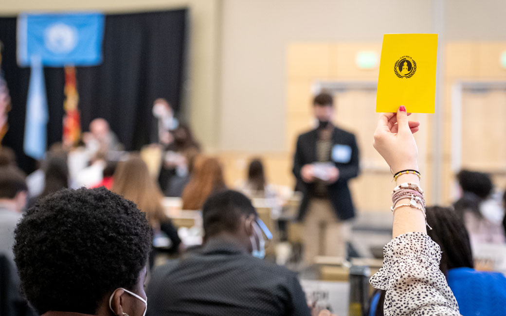Model UN card being held up