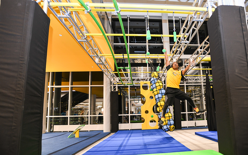 Man competing on ninja warrior course