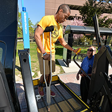 Student getting on paratransit van