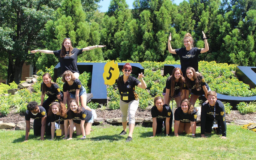 students holding a tiger paw sign