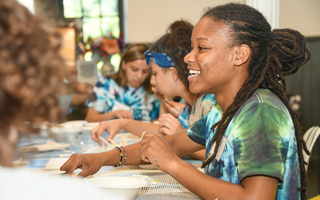 Student do a mosaic at a local community organization. 