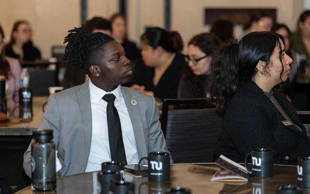 Students listen to a presentation.