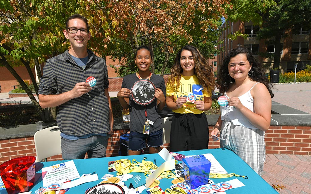 Students register TU community members to vote.