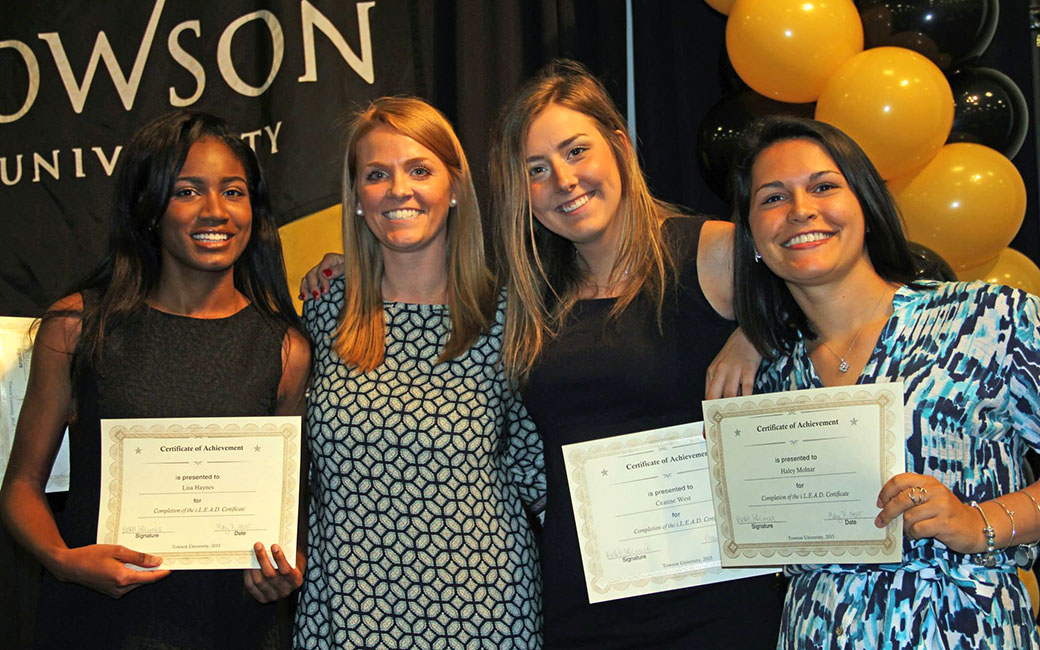 Four women holding certificates