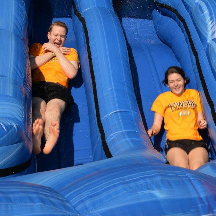 TU students sliding down an inflatible slide