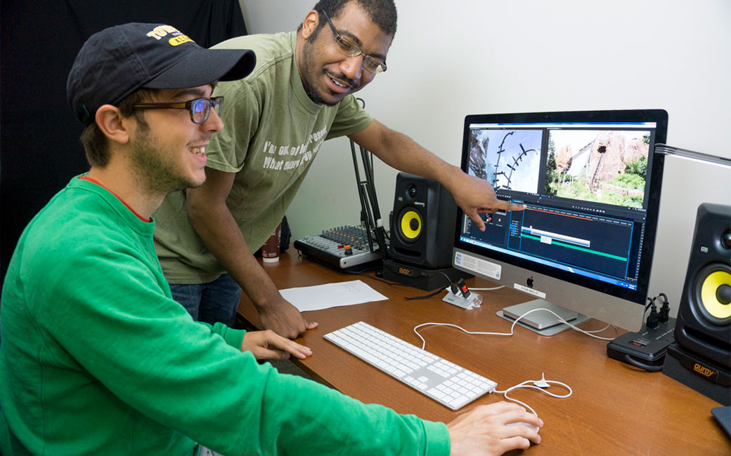 Technology Support Desk staff assisting a student with video editing